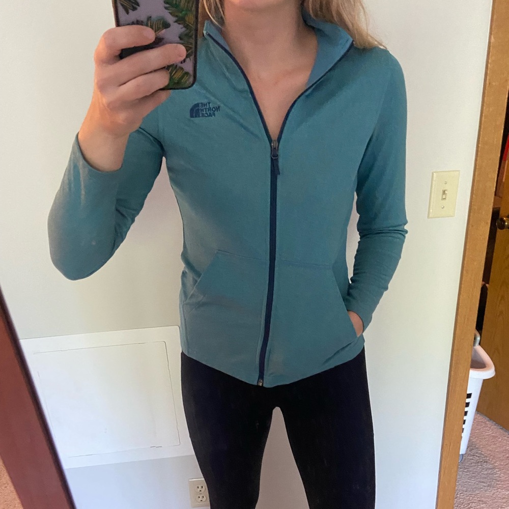 The North Face blue size small zip up jacket with pockets